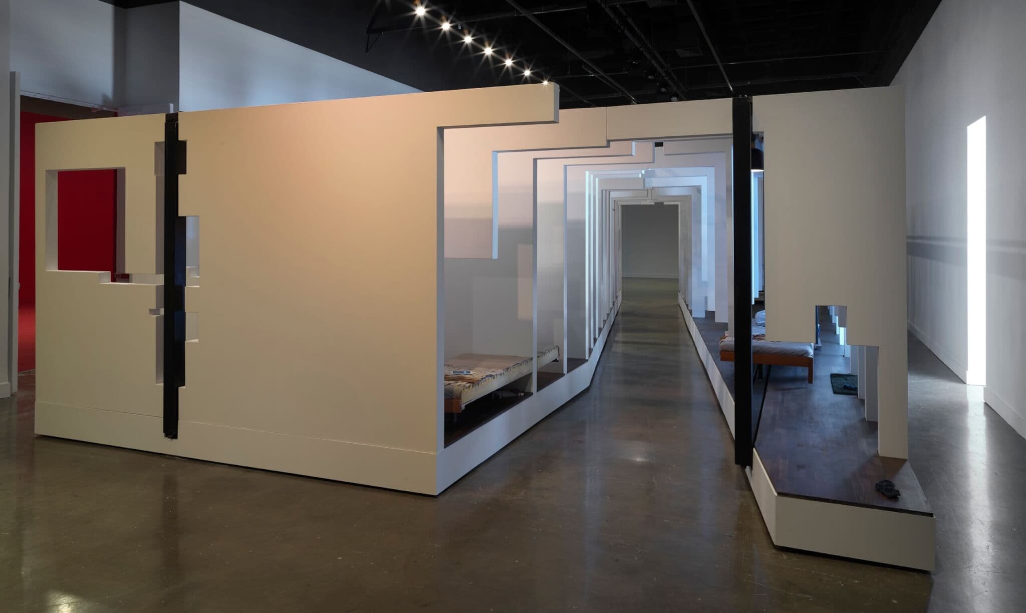 An artwork consisting of partitioned walls that creates a fragmented apartment.